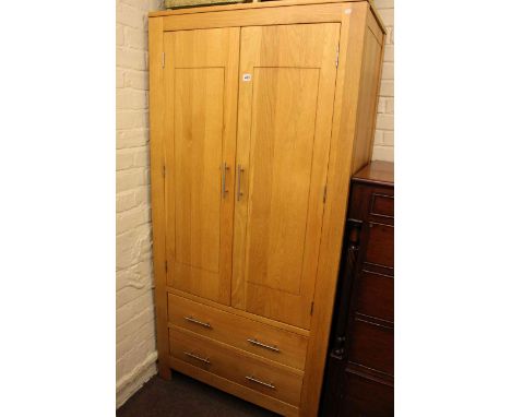 Contemporary light oak wardrobe having double doors above two drawers, 186cm high by 90.5cm wide by 55cm deep, in little used