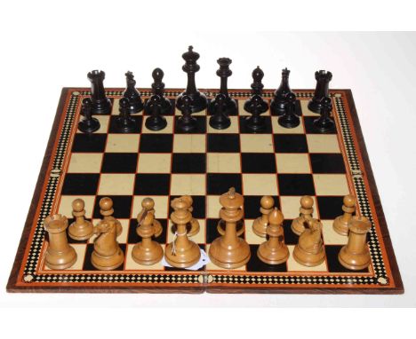 A Staunton boxwood and ebony chess set with mahogany box, board and set of draughts with Jaques &amp; Sons label.