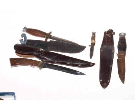 Four knives, three with sheaths, and military style compass.