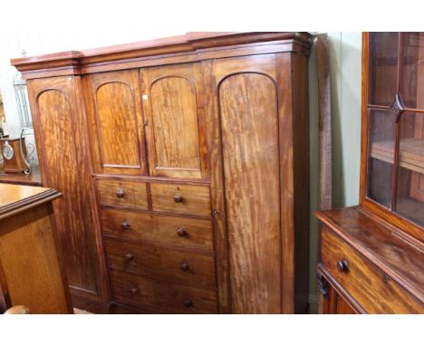 Victorian mahogany inverted breakfront wardrobe having two central arched panel doors above two short and three long drawers 