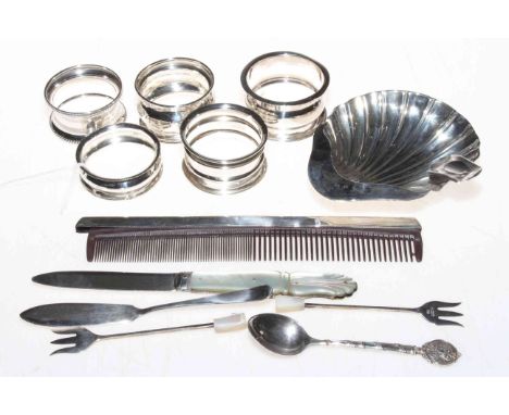 Silver pieces comprising folding fruit knife, five napkin rings, two sardine forks, butter knife, spoon, comb and shell ashtr