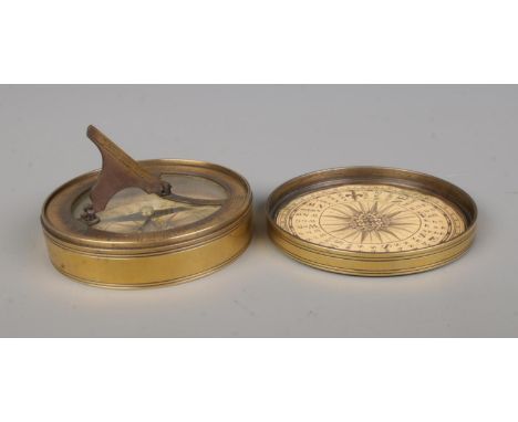 A reproduction circular compass and sundial, housed in brass case.