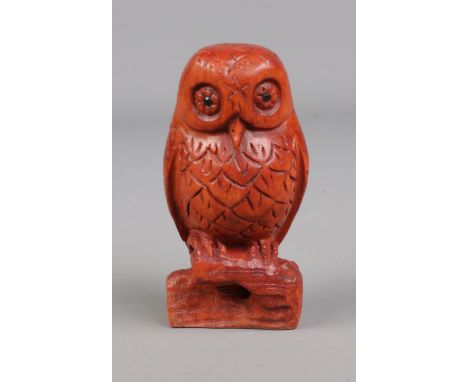 A hand carved hardwood netsuke formed as a owl