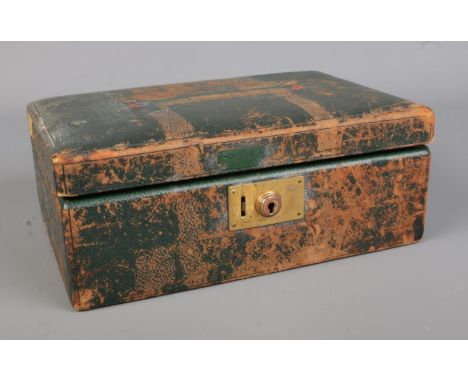 A leather jewellery case, bearing initials E.J.M to the front, containing a quantity of costume jewellery. To include dress r