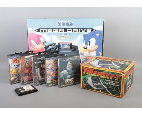A Sega Mega Drive II console, in Sonic 3 sleeve, together with a collection of gaming cartridges and Grandstand Firefox F-7 g