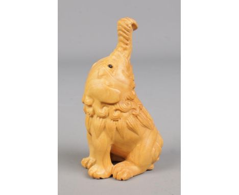 A hand carved hardwood netsuke formed as a elephant