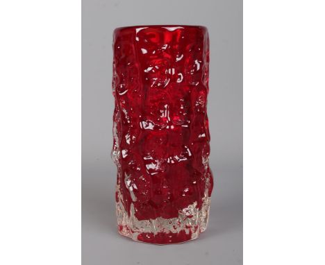 Geoffrey Baxter for Whitefriars; a ruby red moulded glass bark vase of cylindrical form. Height: 15.5cm.