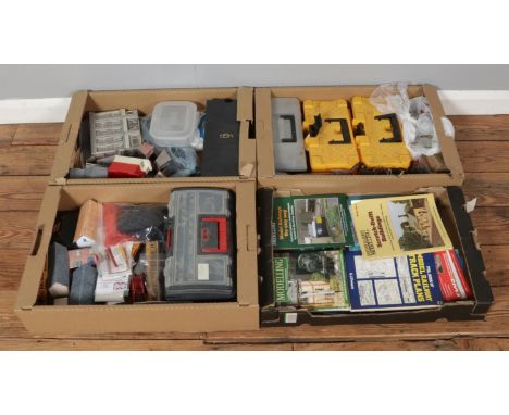 Four trays of model railway collections, featuring guides and books, essential tools, buildings, parts, wires, motors, contro