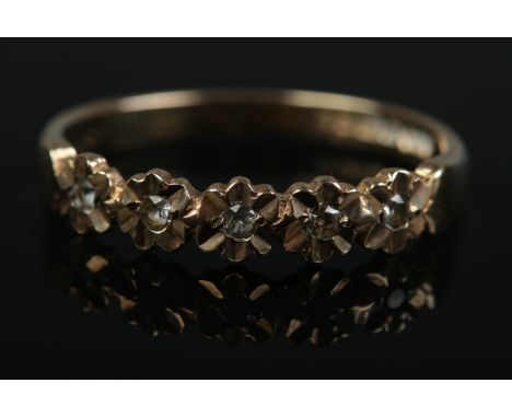 A vintage 9ct gold dress ring set with five clear paste stones in floral setting. Size P. 1.81g.
