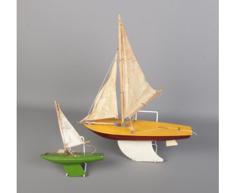 Pair of vintage wooden model yachts.  Length 21cm (small) and 36cm (large).