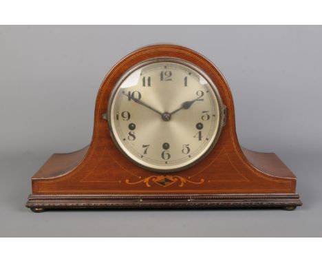 A mahogany cased dome top mantle clock with stringed border and diamond inlay to the body. With silvered dial and Arabic Nume