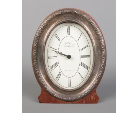 A vintage sterling silver framed "R. Carr" table clock, featuring a quartz battery movement with a wooden case.  Height 17cm,