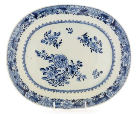 A Chinese export blue and white meat dish, Qianlong, painted with flower sprays and sprigs within a ruyi head and complex bor
