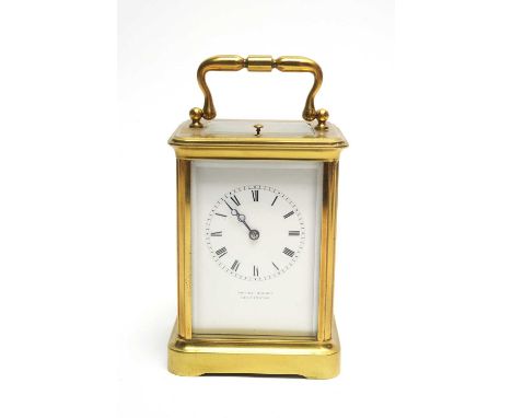 A late 19th Century brass cased repeater carriage clock, retailed by Henry Bright, Lemington, the signed white enamel roman d
