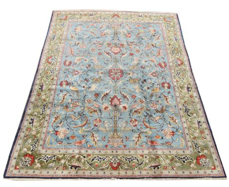 Antique Qum carpet, with floral scrolls on light blue ground, 345 x 228cms.