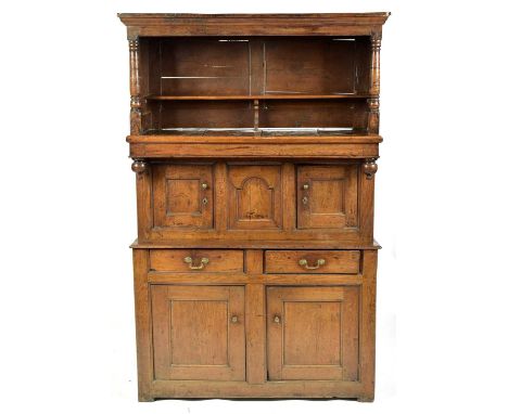 A 17th Century and later oak court cupboard, the projecting cornice above an open shelf, flanked by turned supports, above a 