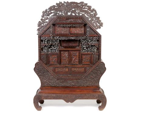 A Japanese carved netsuke display cabinet, Meiji period, fitted an arrangement of cupboards, drawers and shelves, raised on a