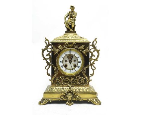 An early 20th Century brass-cased mantel clock, the white enamel roman dial fitted an eight-day barrel movement with dial vis
