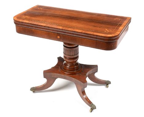 A 19th Century rosewood and boxwood lined card table, the hinged rectangular top with inlaid fleur-de-lis, enclosing a baize 