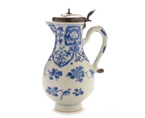 A Kangxi blue and white water jug of pear shape, decorated with birds and flowering branches, later Persian silvered colour m
