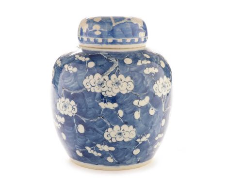 A late 19th/ early 20th Century Chinese blue and white ginger jar and cover, decorated with flowering prunus on a cracked ice