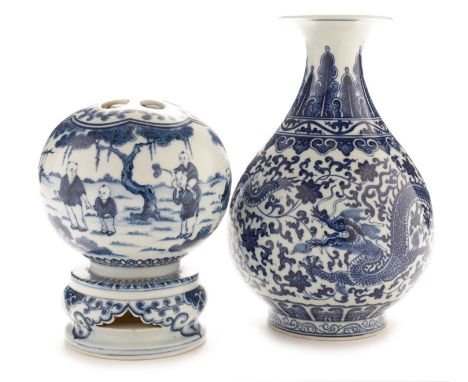 A reproduction Chinese blue and white vase, decorated with dragons and scrolling foliage between lappet and scroll borders, Q