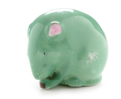 A Royal Worcester figure of a mouse, circa 1934, depicted eating a seed, glazed in green with pink ears, printed mark in gree