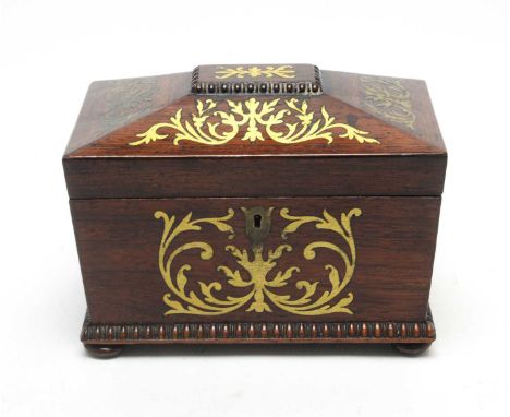 A Regency brass inlaid rosewood tea caddy, of sarcophagus form, the lacquered brass inlay of leaf scroll design, the cover op