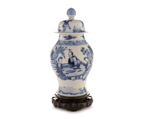 A late 19th Century Chinese blue and white vase and cover of baluster form, painted with a continuous scene of female figures