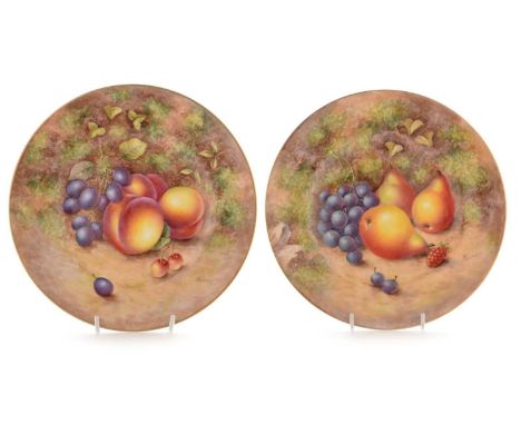 Two Royal Worcester fruit painted dessert plates by John H Freeman, one decorated with peaches, grapes and cherries, the othe
