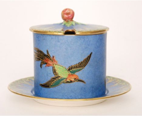 Crown Devon - A 1930s Art Deco drum shape preserve pot and stand decorated with a gilt and enamel stylised bird in flight wit