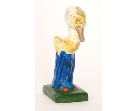 Clarice Cliff - Mrs Duck - An early figure of a duck wearing a mop cap and blue enamelled skirt with walking stick, raised to