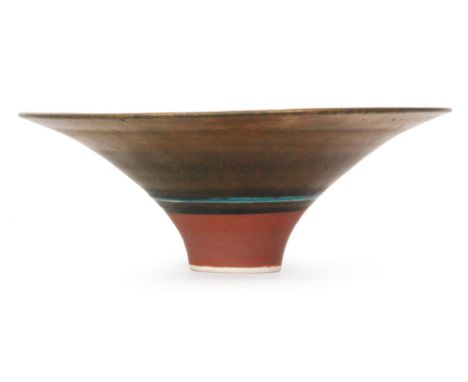 Lucie Rie - A 1980s footed bowl with golden manganese glaze and rings of turquoise and charcoal black around a terracotta foo