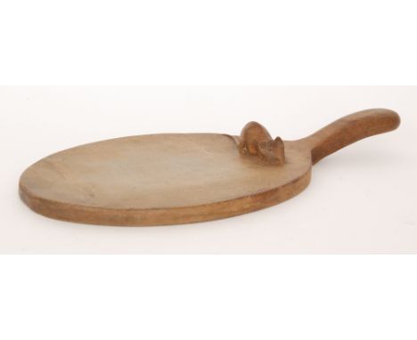 Robert 'Mouseman' Thompson - A single handled oak cheeseboard of oval form, with adzed finish, with carved 'mouse signature',