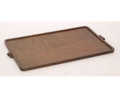Robert 'Mouseman' Thompson - An oak serving tray of rounded rectangular form, with adzed surface and twin carved 'mouse signa