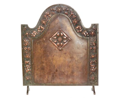 In the manner of Bromsgrove Guild - A copper firescreen of arched form, with copper panels within brass borders, detailed wit