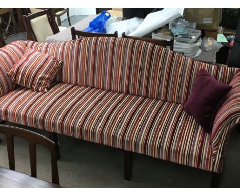 A George 111 style three seater sofa with scrolled ends upholstered in candy stripe on square tapering legs united by a under