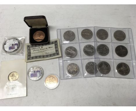 A collection of coins including WW2 Gibraltar crowns, an Apollo 8 commemorative medallion, a D-Day £5 coin and 2 Adam Smith £