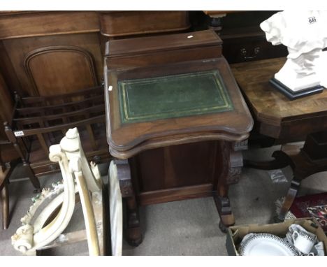 A reproduction davenport desk with green leather.