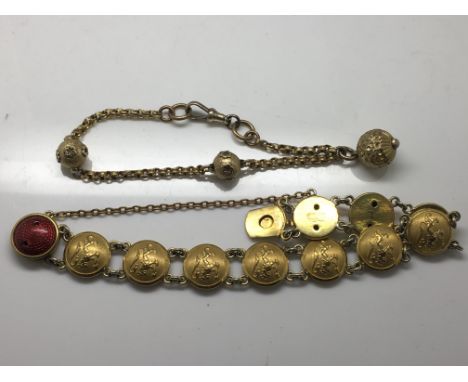 A Scandinavian Sporrone, gilt metal disc bracelet decorated with lions and red enamel clasp and a Victorian example