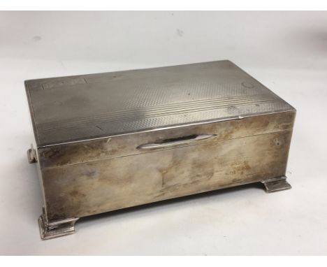A silver cigarette box with engine turned decoration, Birmingham 1953.