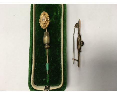 A 9ct gold brooch (weight approx 1.2g) and a 15ct gold tie pin (Weight approx 2.8g)