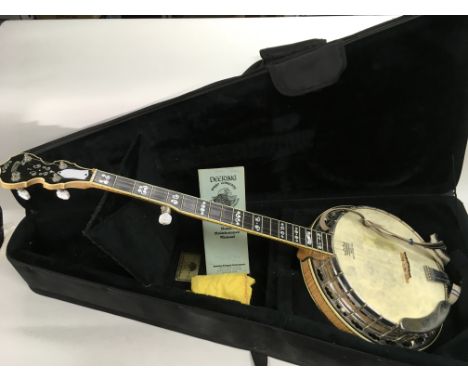 A Deering Calico banjo, stamped 1999 to back of headstock, together with hard carry case and maintenance manual.