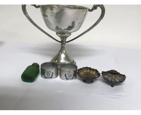 A silver twin handle cup , a pair of enamel and silver napkin rings , a pair of silver salts