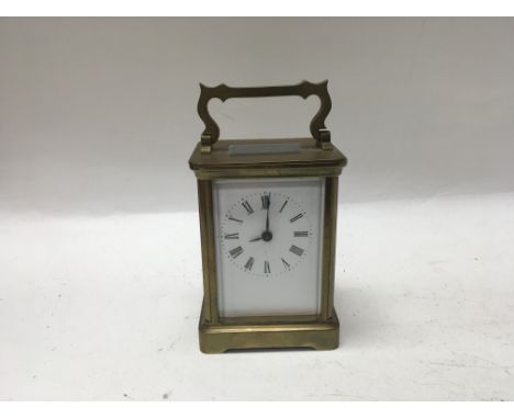 A French brass carriage clock with a key.