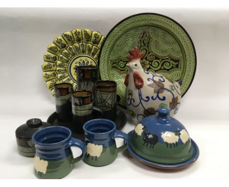 A box of various ceramics including a pottery chicken, two chargers, cottage ware tea service etc.