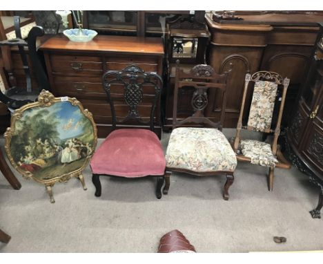 A collection of three Edwardian nursing chairs and a French style fire screen