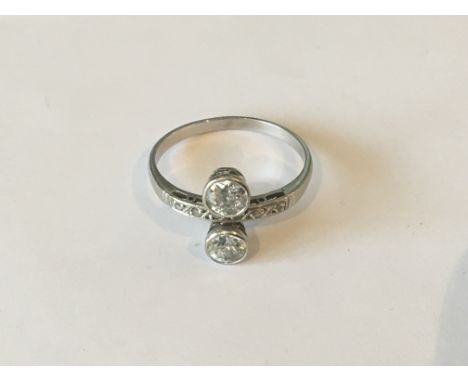 A white or platinum unmarked gold two diamond old cut ring