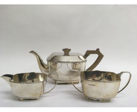 A three piece silver tea service comprising matching teapot, milk jug and sugar bowl, Bravington’s, Sheffield 1939. Over a ki