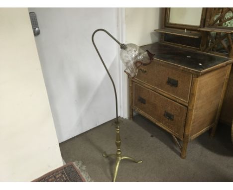An unusual brass standing lamp with a glass tulip shaped shade.